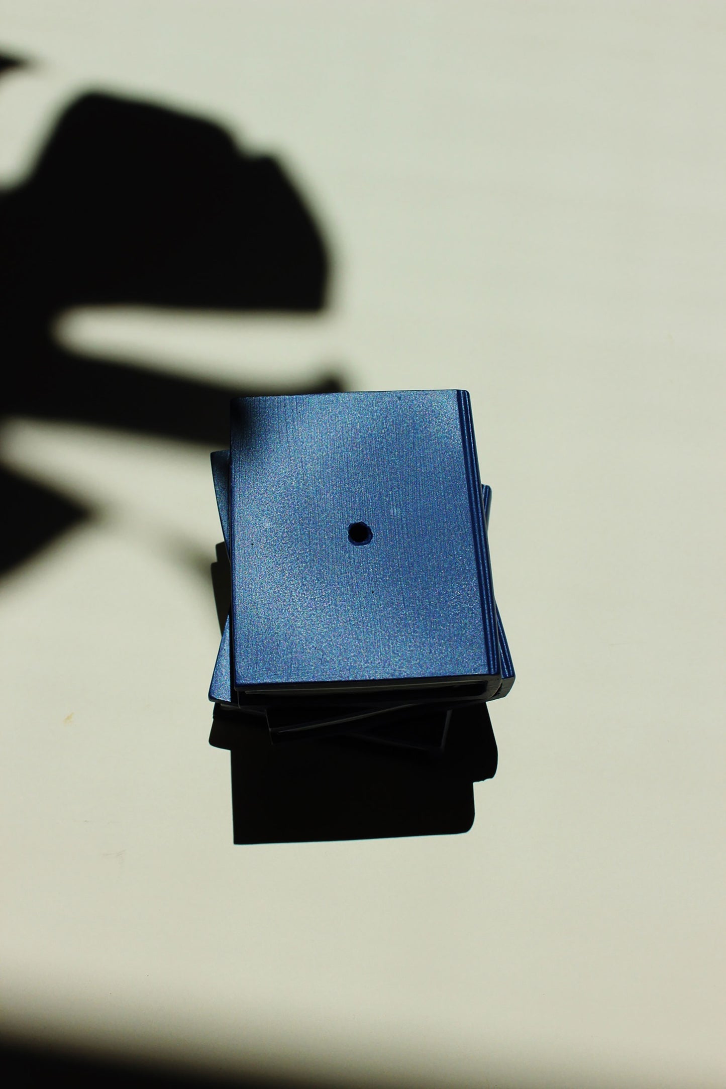 Blue and black square objects on a light background - incense stick holder by acquired taste
