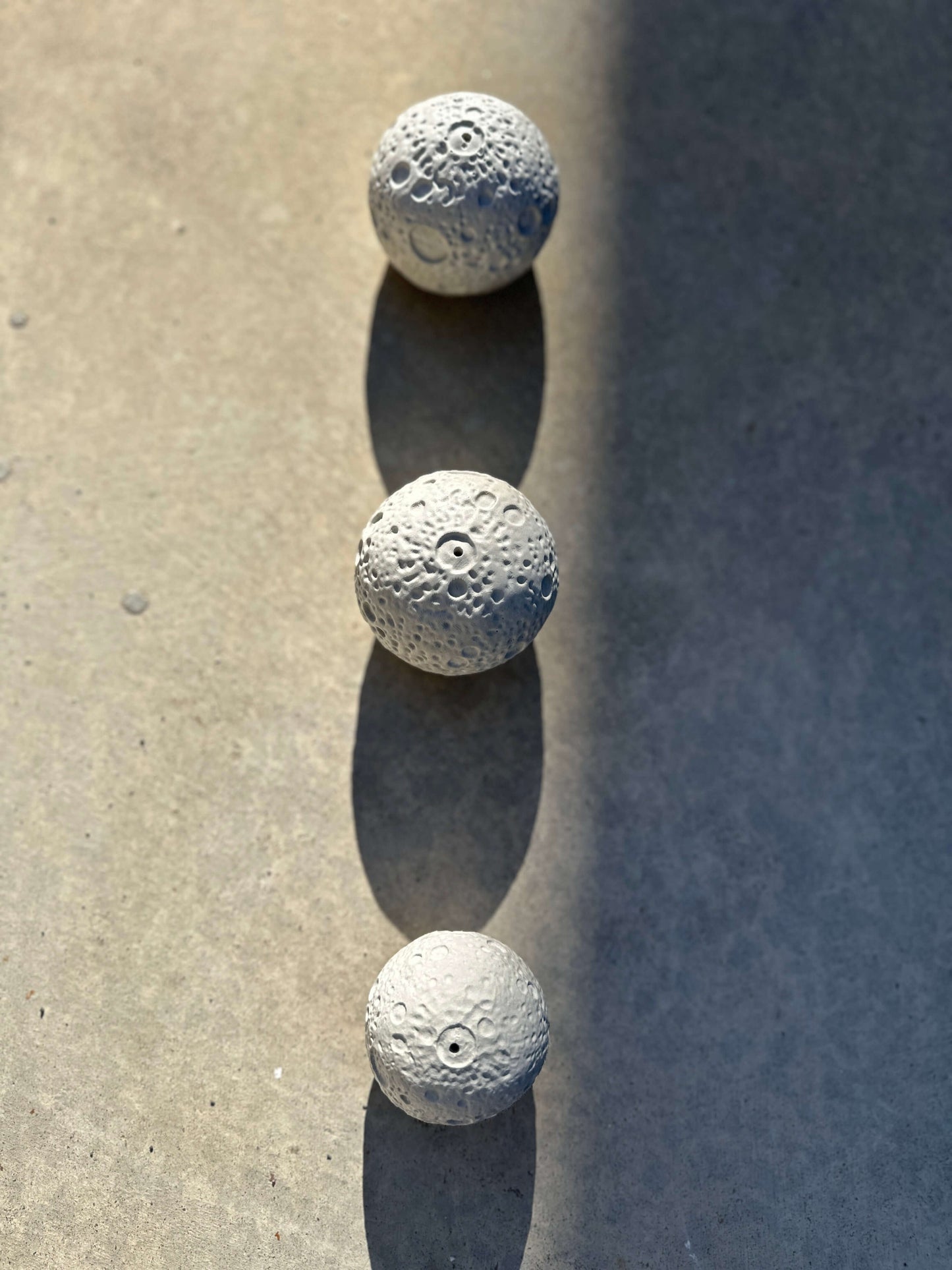 An image of three moons incense holder lined up