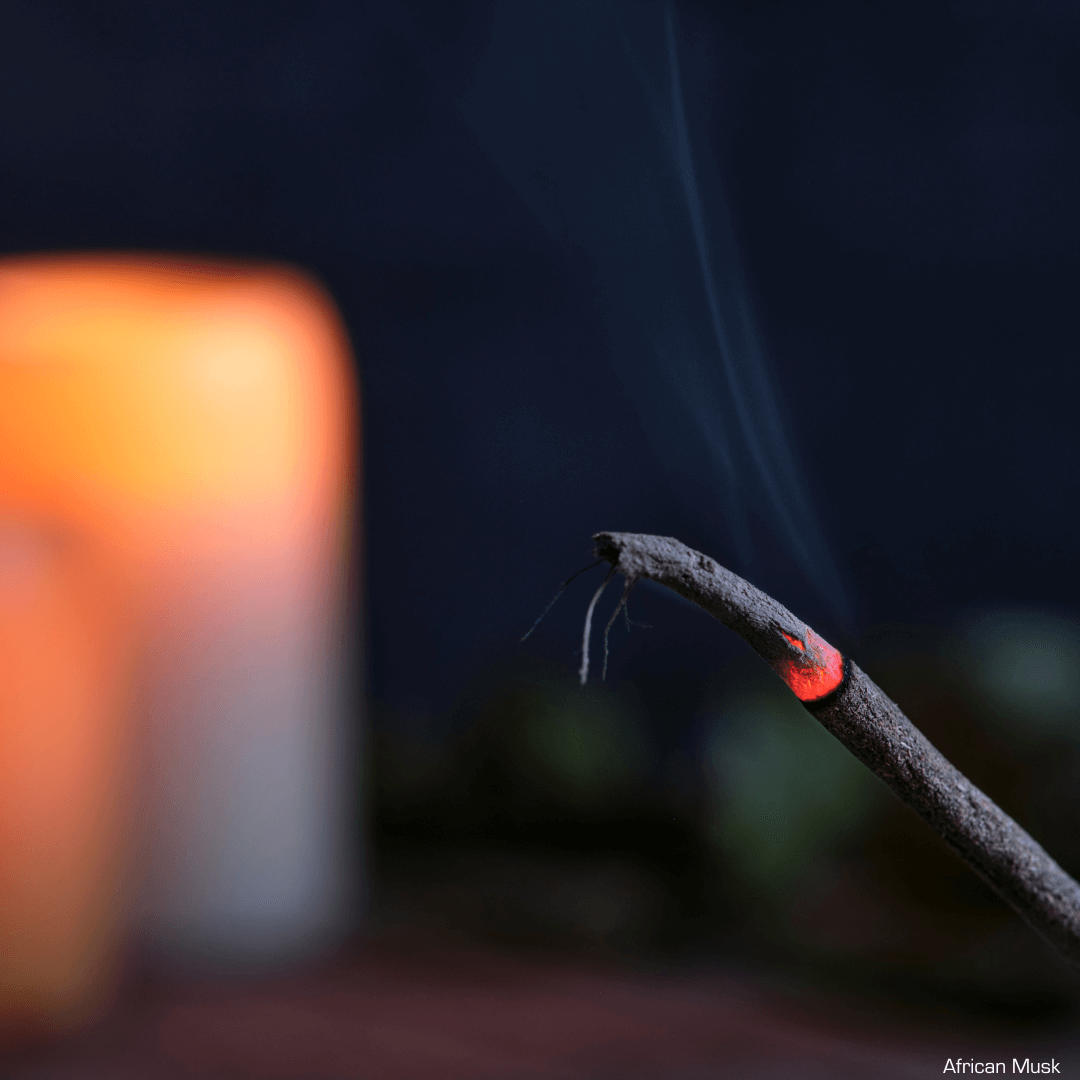 Incense stick Burning next to a candle