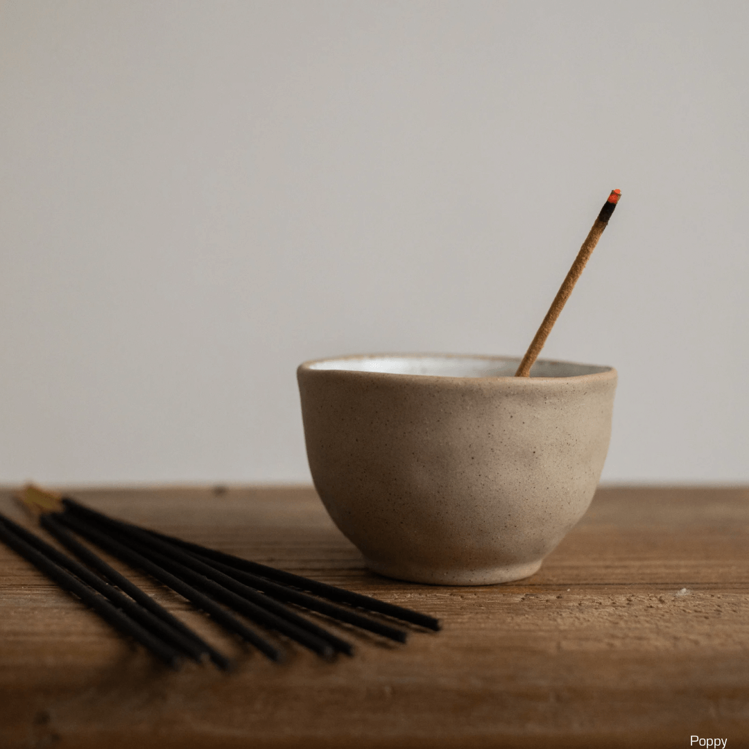 Incense sticks lit in a bowl