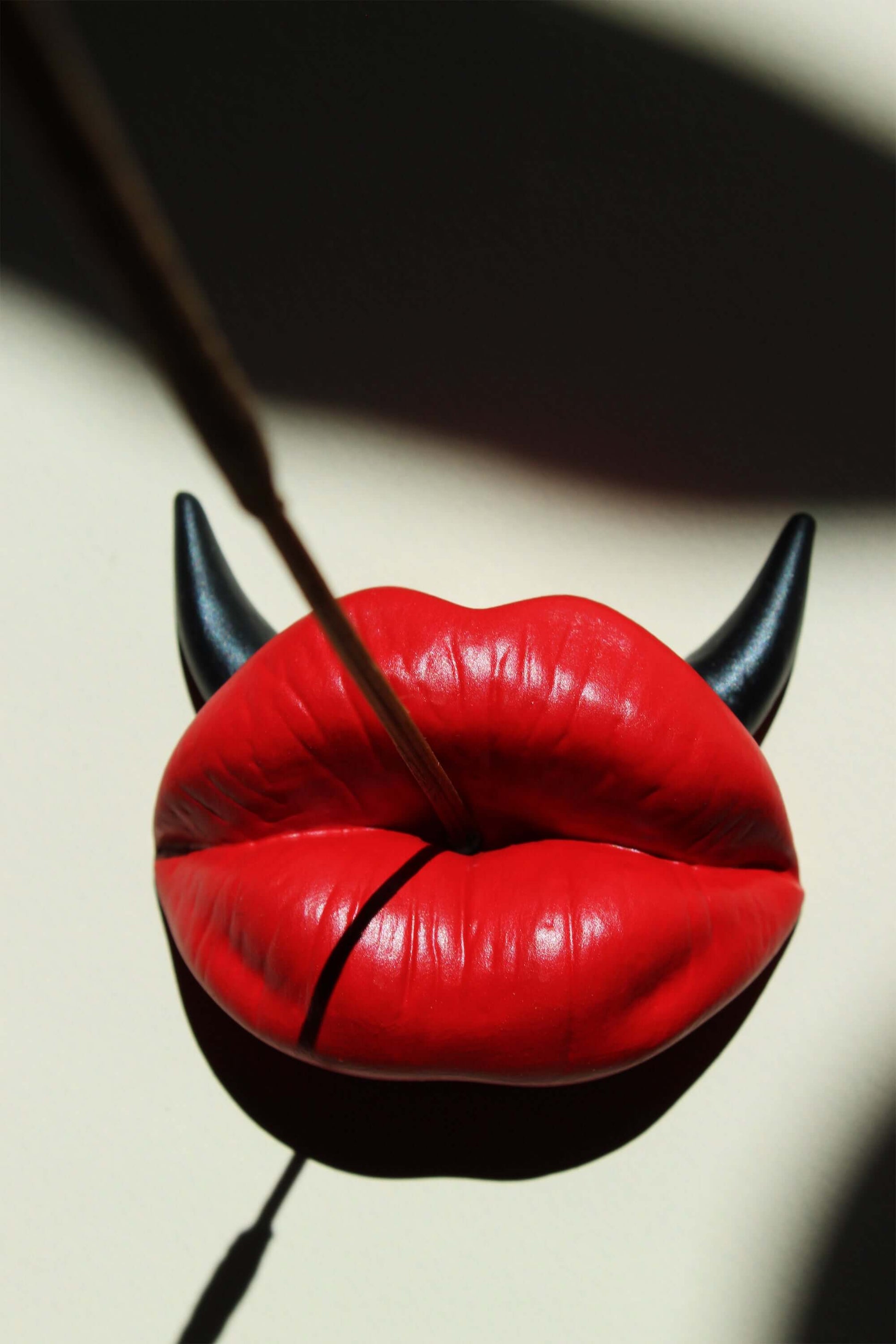 Red lips incense stick holder with black horns