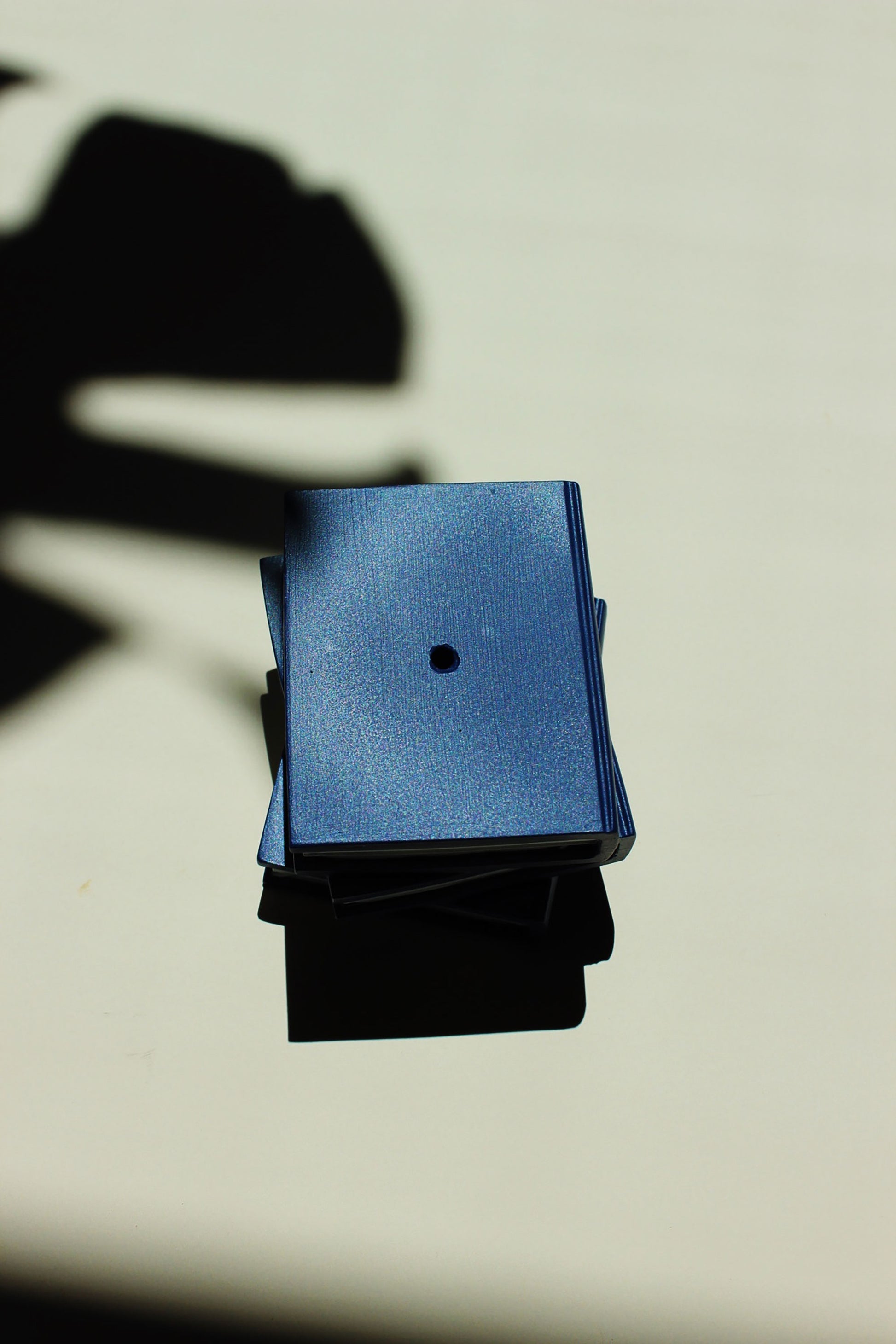 Blue and black square objects on a light background - incense stick holder by acquired taste