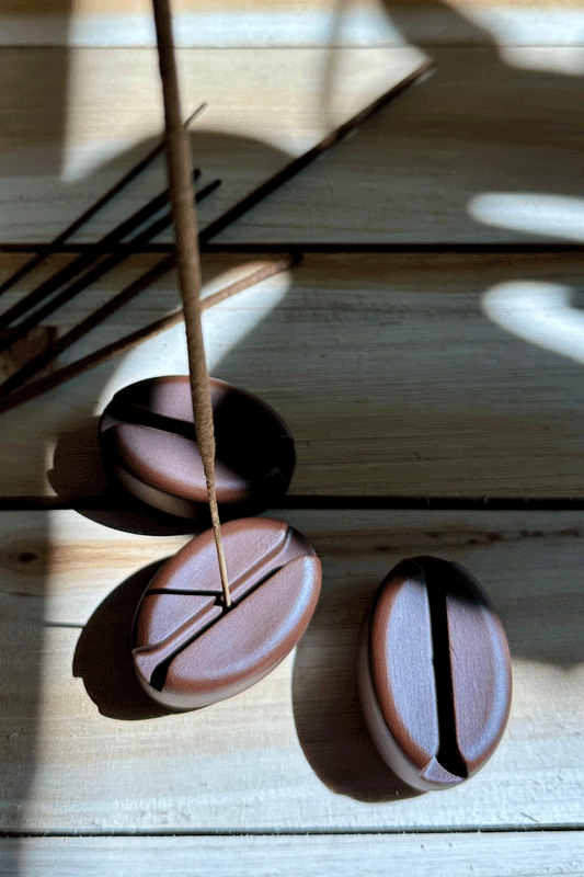 espresso bean incense stick holder on wooden board