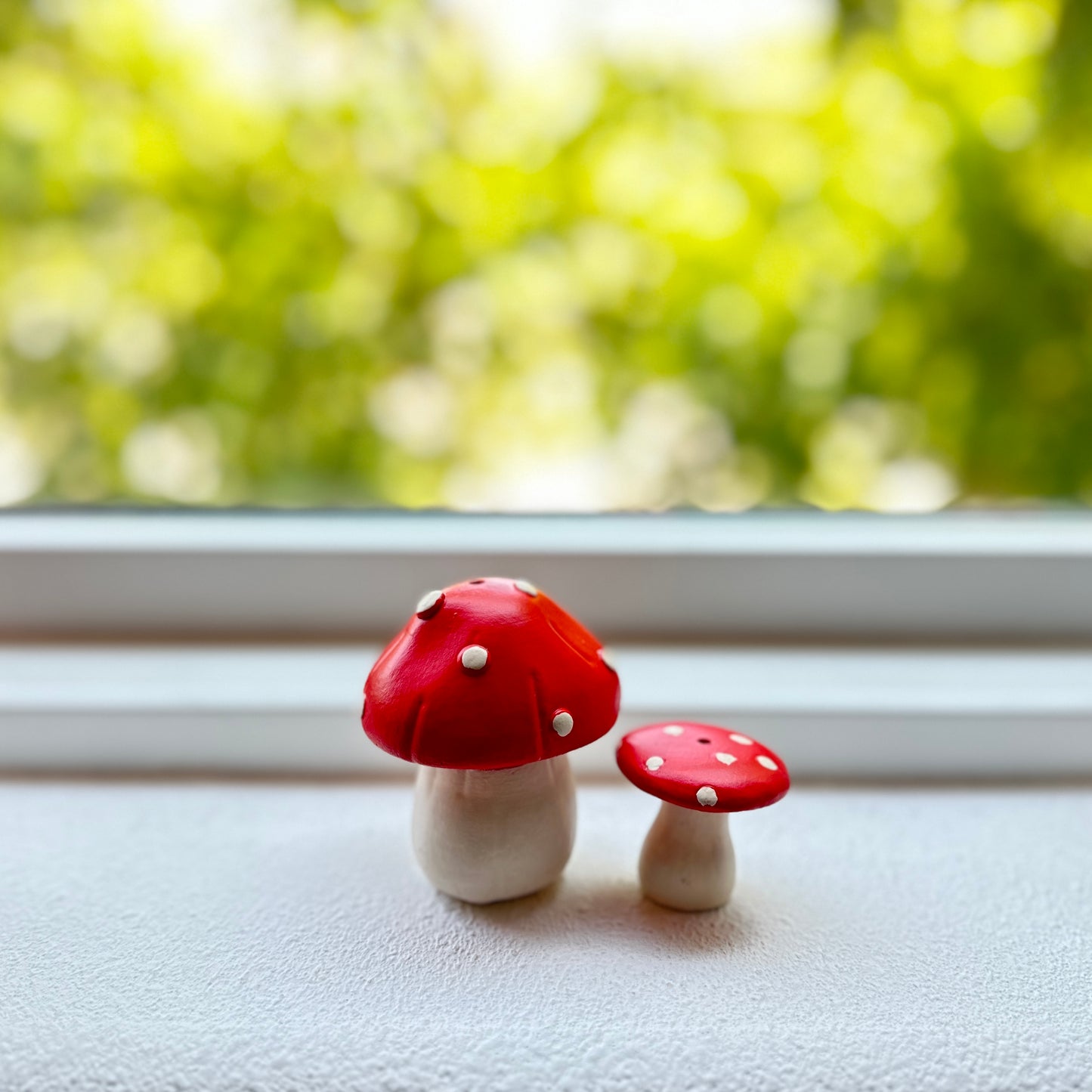 Mushroom-shaped incense holder on windowsill.