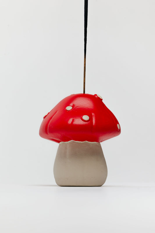 Mushroom-shaped lamp with red cap and beige base on a white background - incense holder