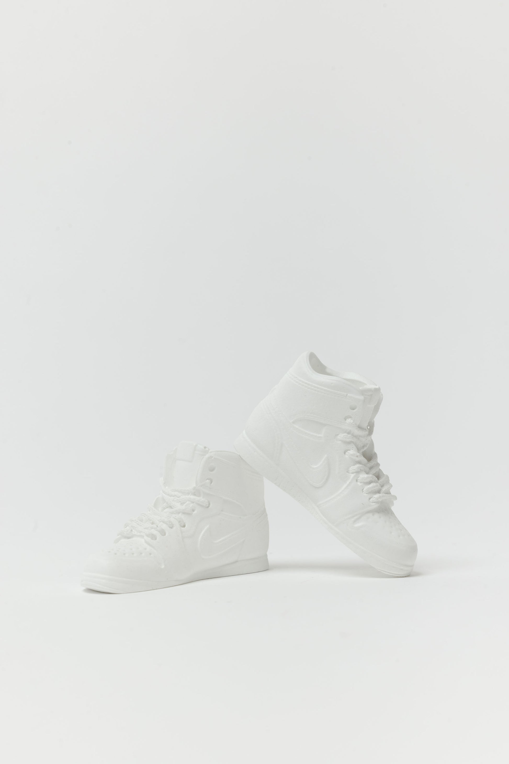 White high-top sneakers on a light gray background - incense holder