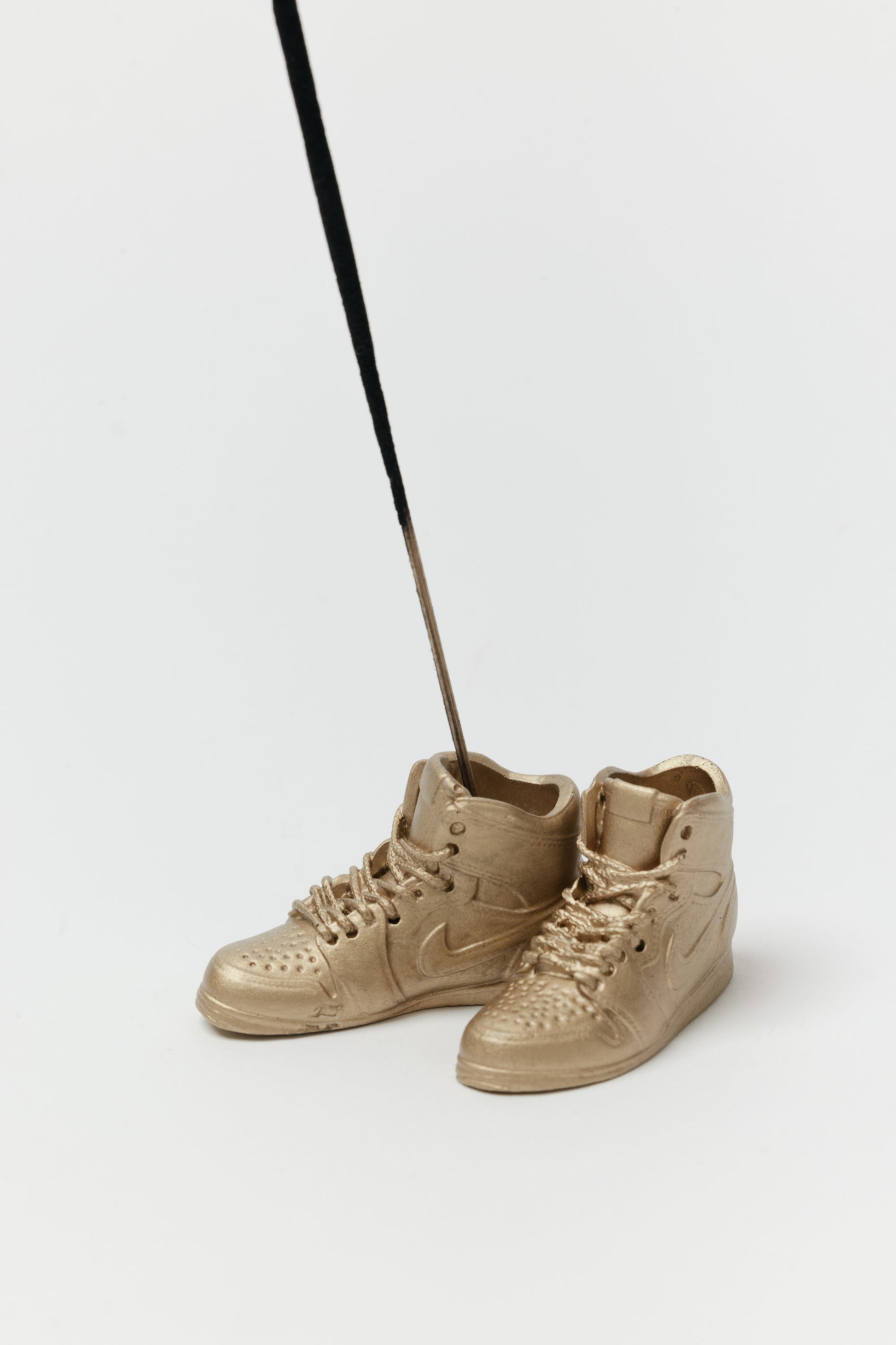 Beige high-top sneakers on a white background ncense holder
