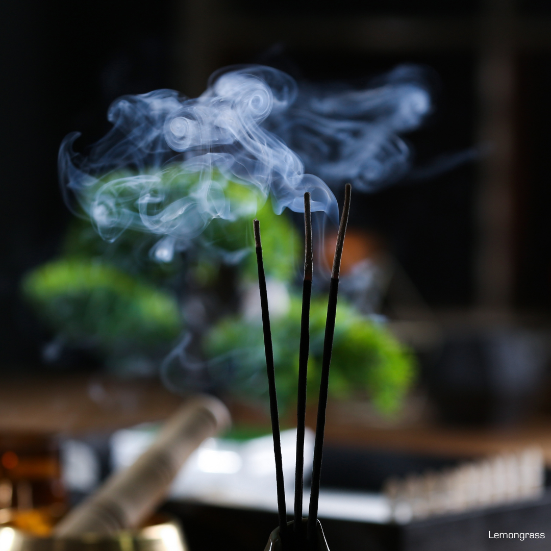 Several incense sticks burning on a table