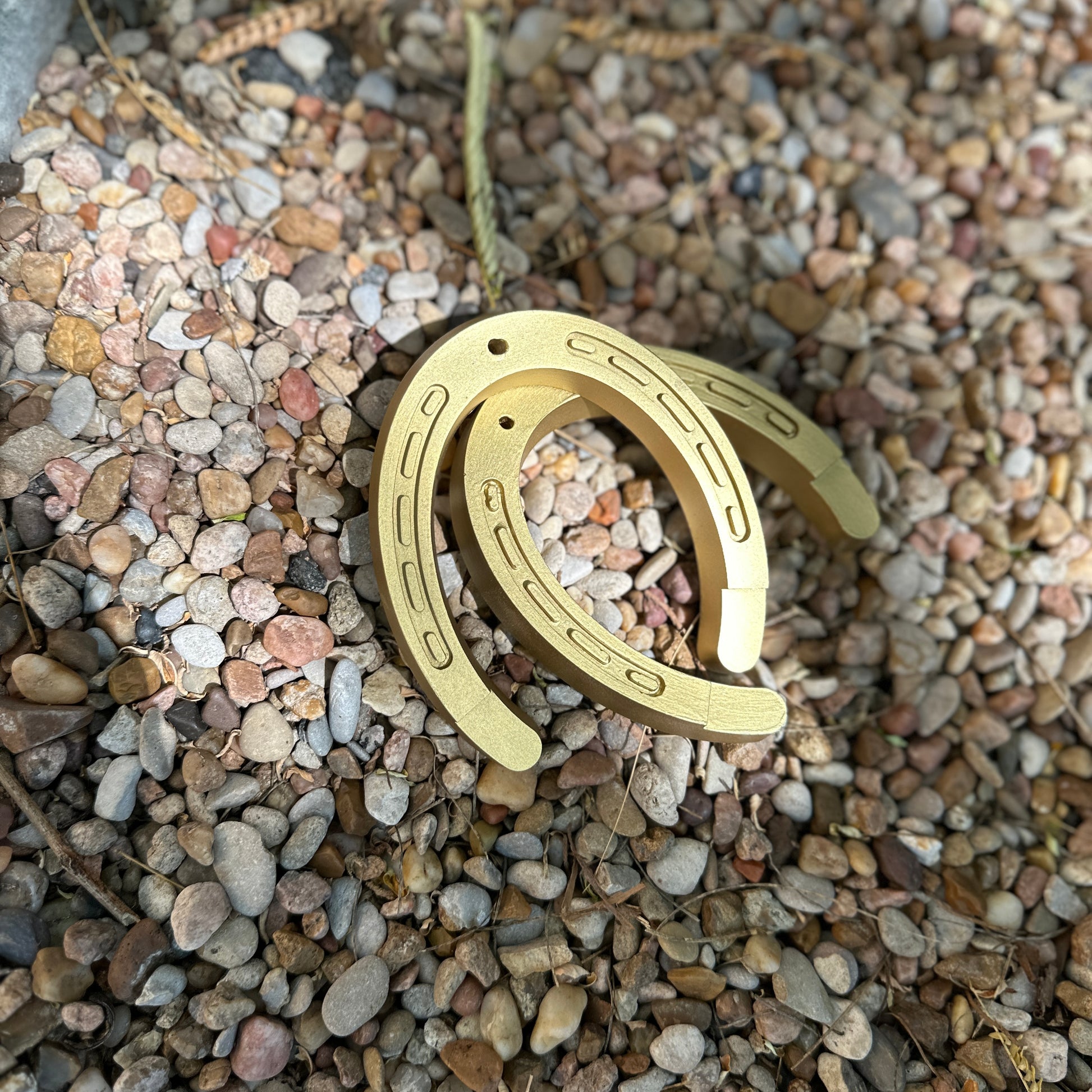 Two gold horseshoe incense holders