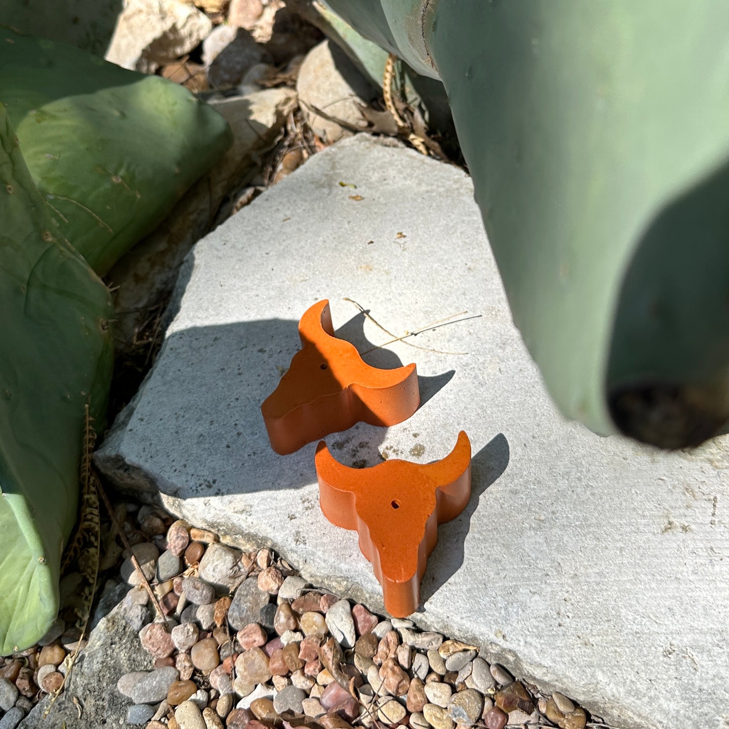 Two longhorn incense holders on the ground